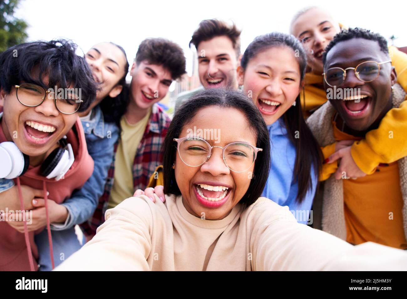 Big group of cheerful young friends taking selfie portrait. Happy students people looking at the camera smiling. Concept of community, colleague Stock Photo