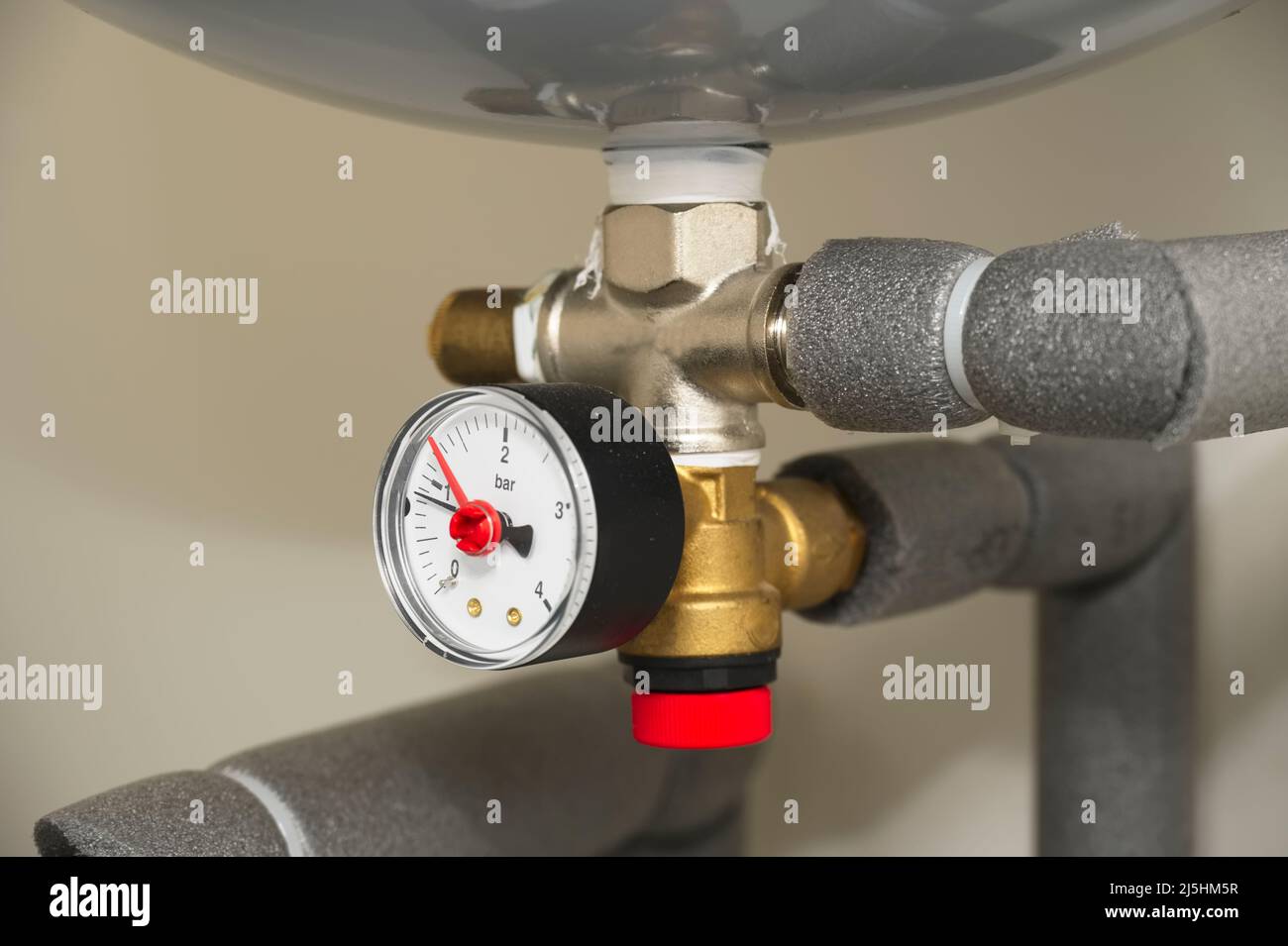 Pressure gauge on domestic boiler expansion vessel inside house Stock