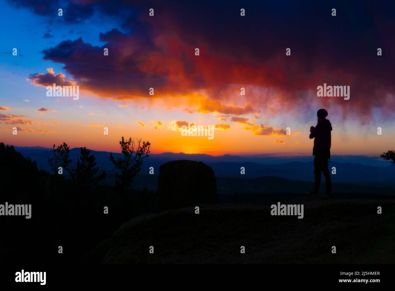Silhouette of Person at Sunrise with colors Stock Photo