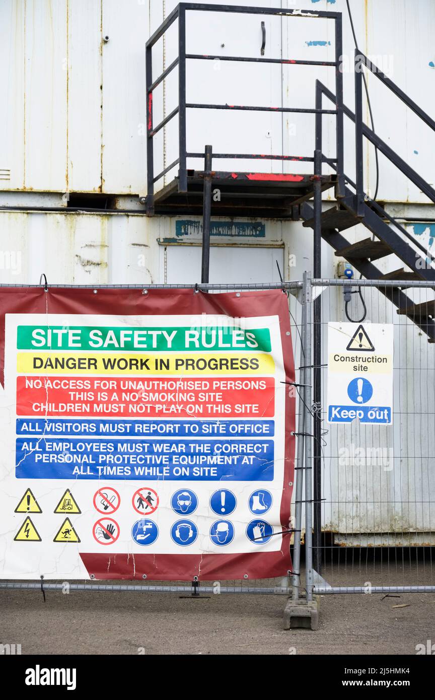 Construction site health and safety message rules sign board signage on fence boundary Stock