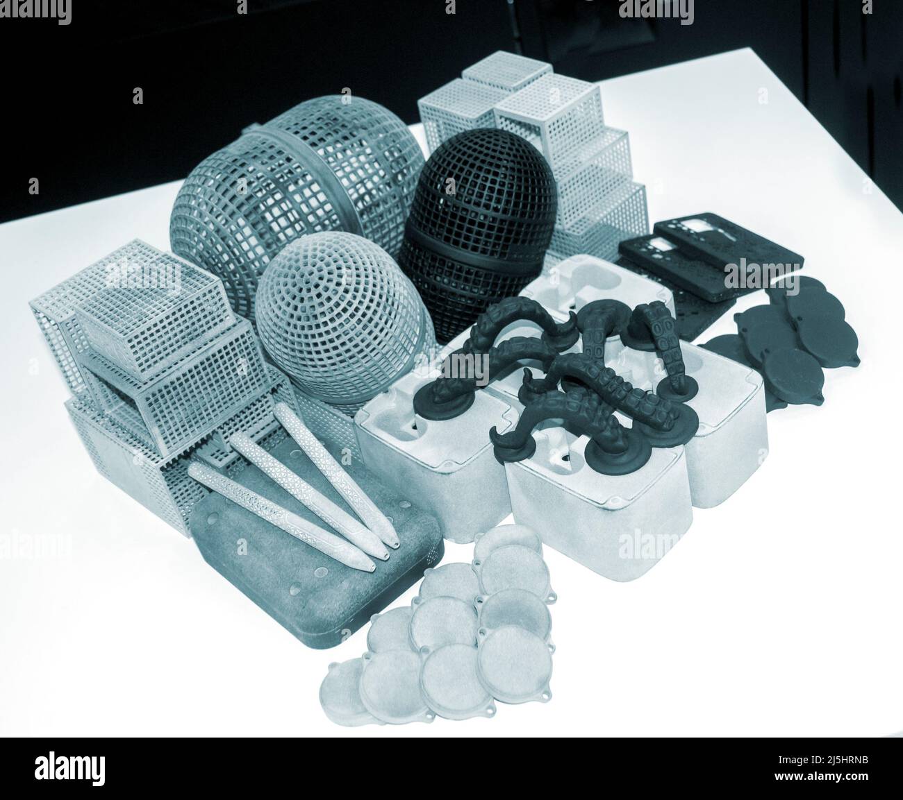 Many different models printed on 3D printer. Gray and black objects printed Stock Photo