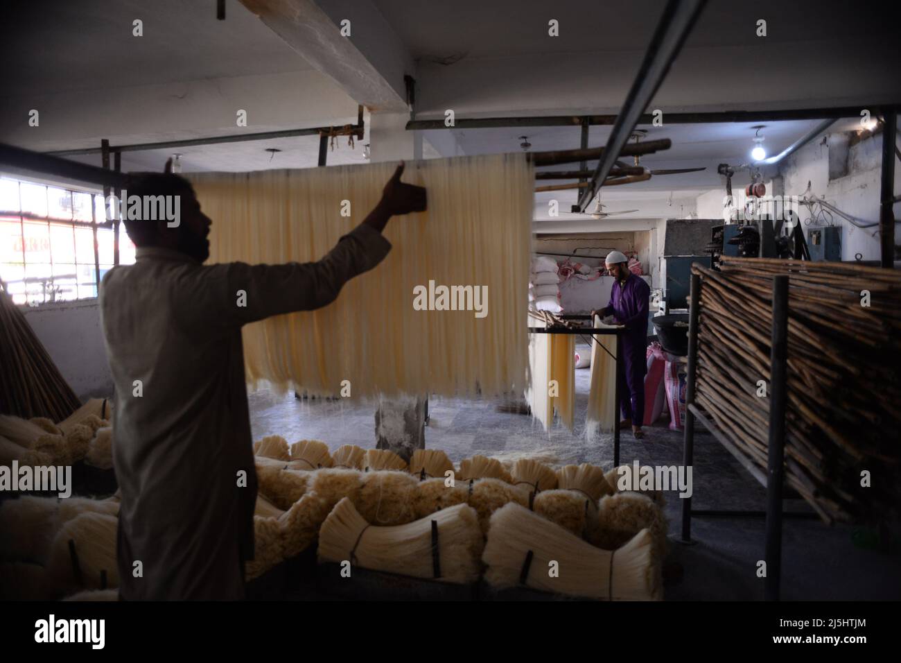 Rawalpindi, Pakistan. 23rd Apr, 2022. Worker arranges rice vermicelli