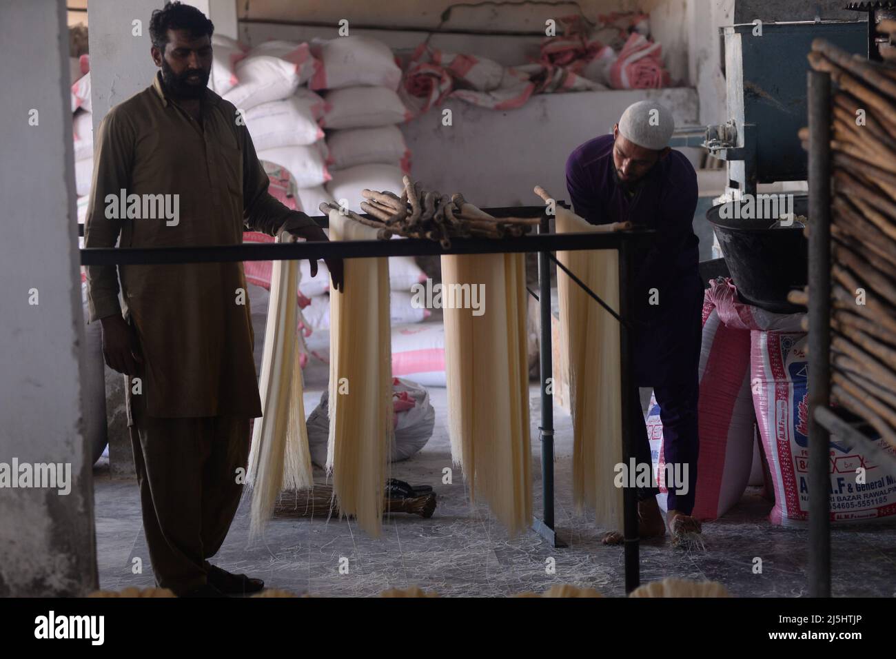 Rawalpindi, Pakistan. 23rd Apr, 2022. Worker arranges rice vermicelli