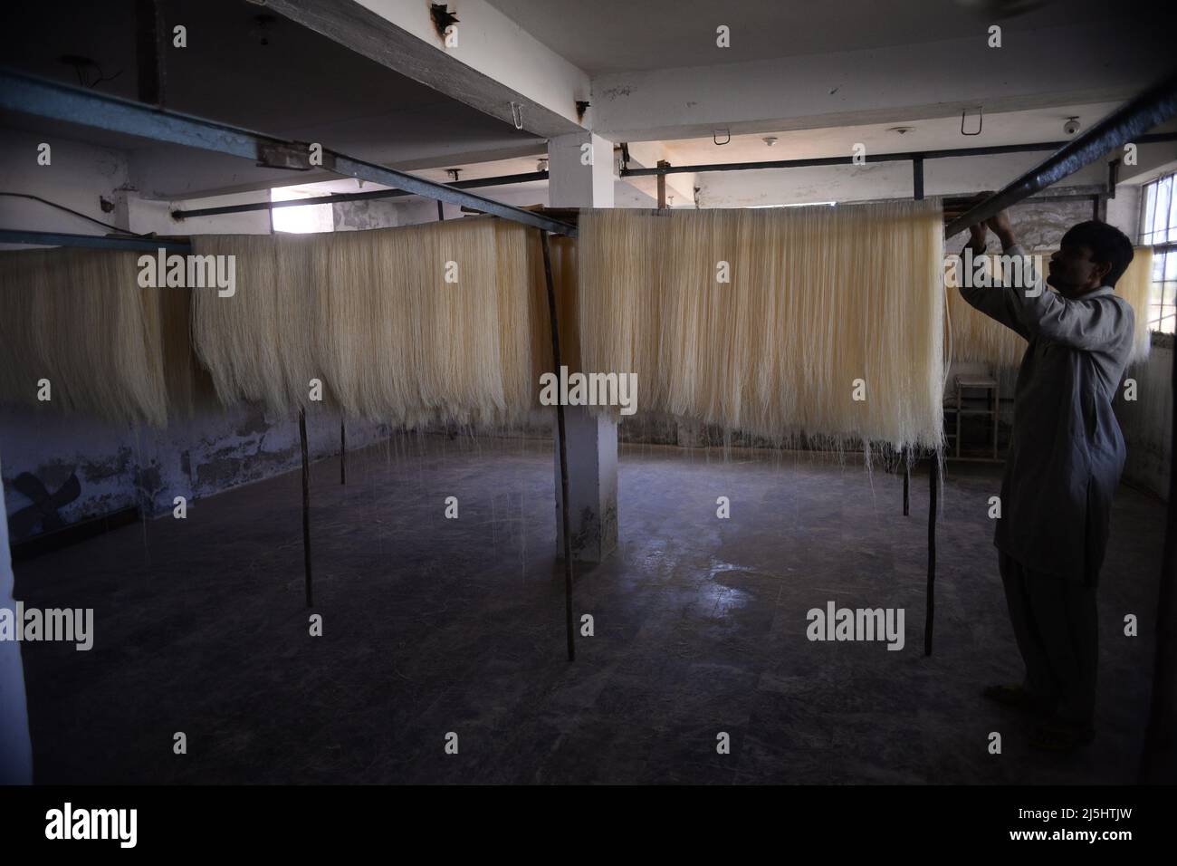 Rawalpindi, Pakistan. 23rd Apr, 2022. Worker arranges rice vermicelli