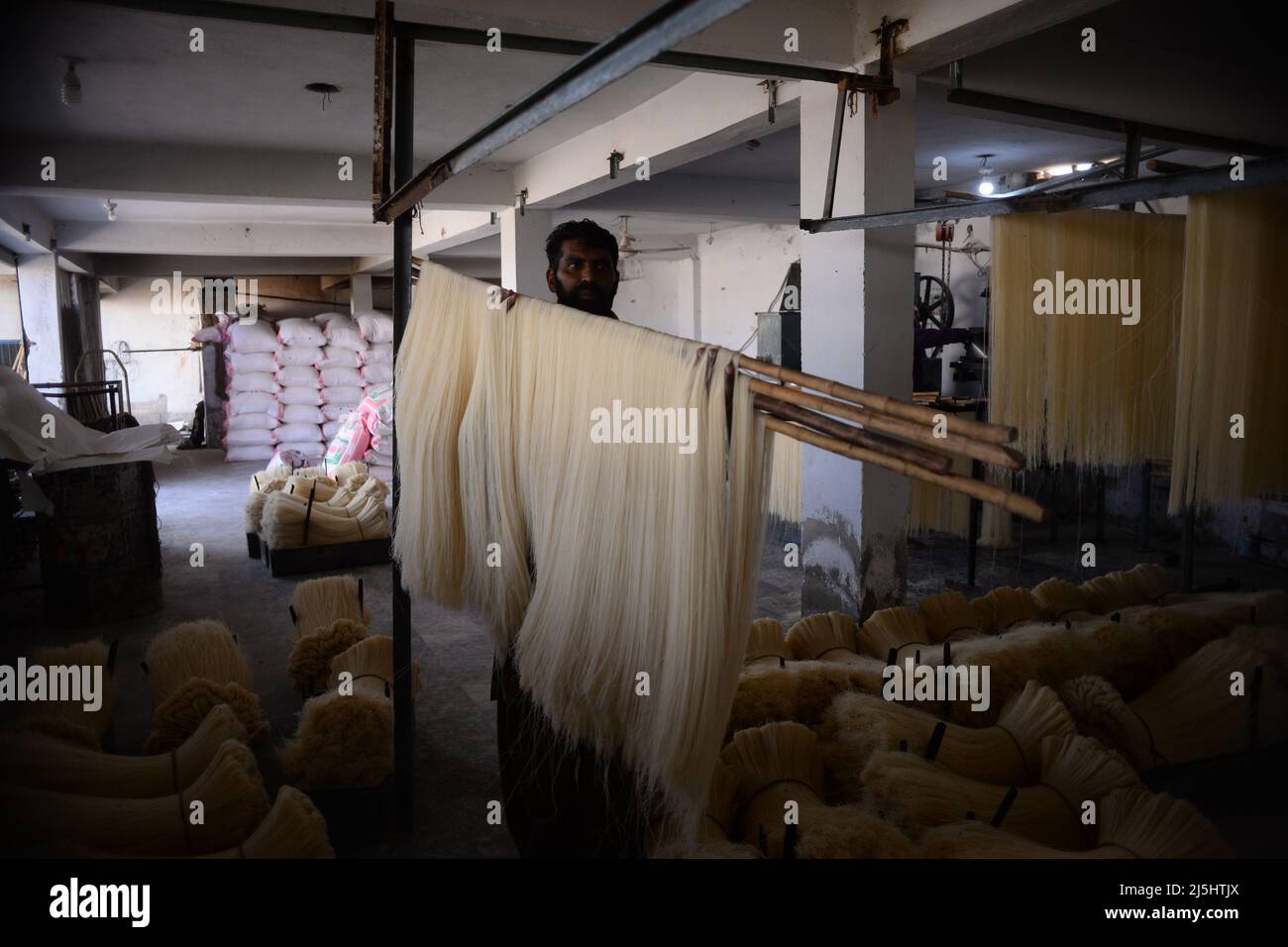 Rawalpindi, Pakistan. 23rd Apr, 2022. Worker arranges rice vermicelli