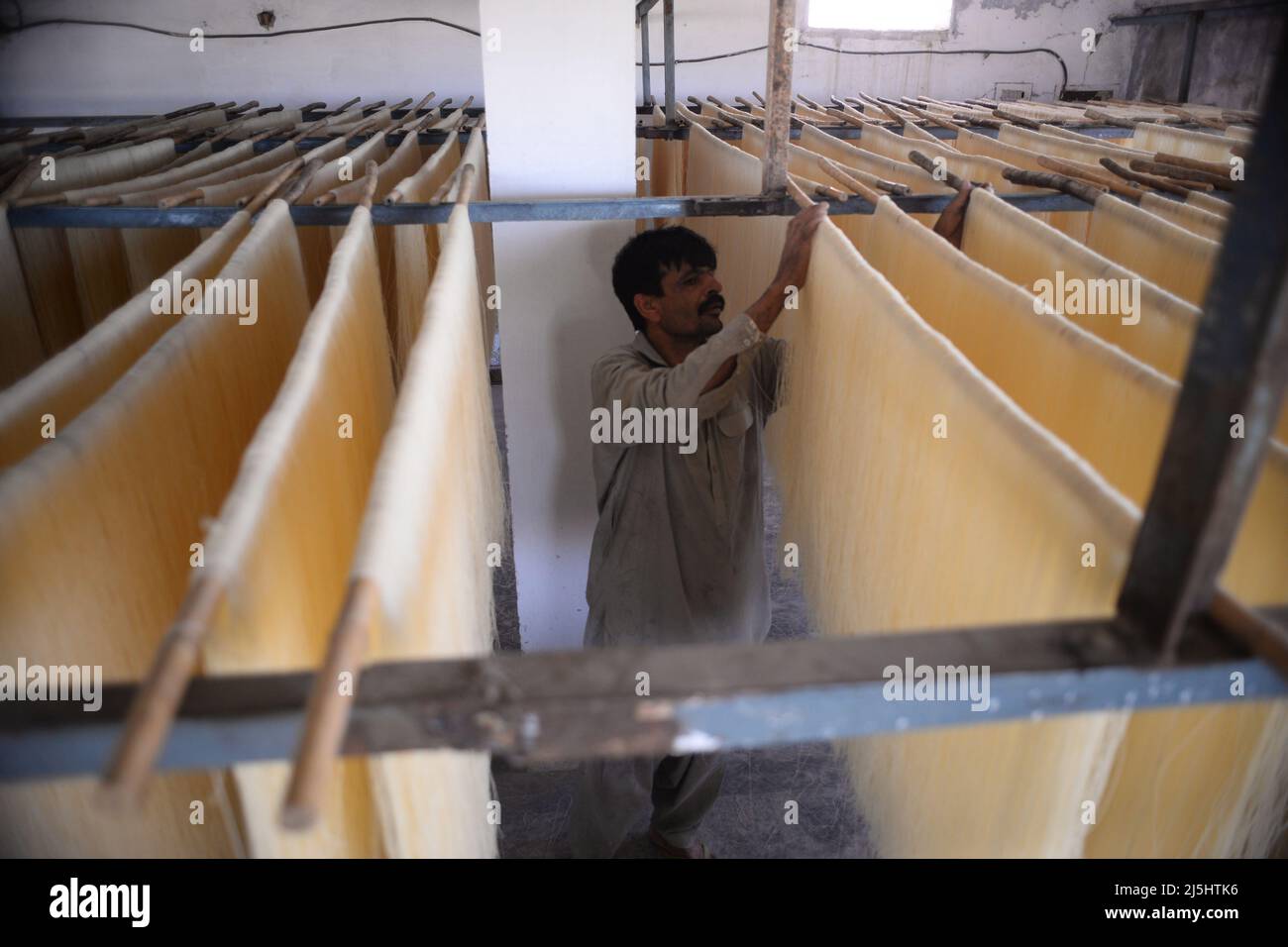 Rawalpindi, Pakistan. 23rd Apr, 2022. Worker arranges rice vermicelli