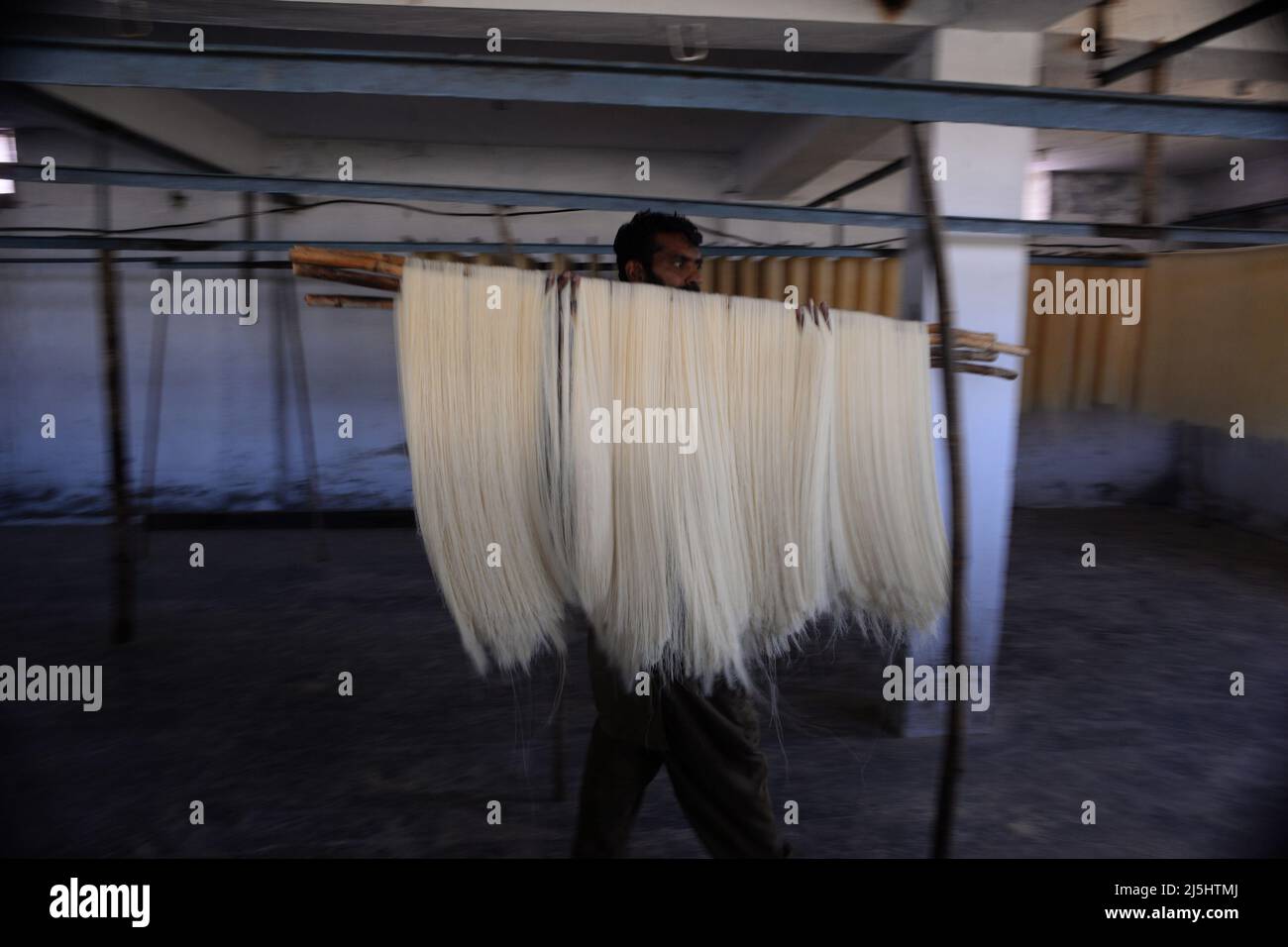 Rawalpindi, Pakistan. 23rd Apr, 2022. Worker arranges rice vermicelli