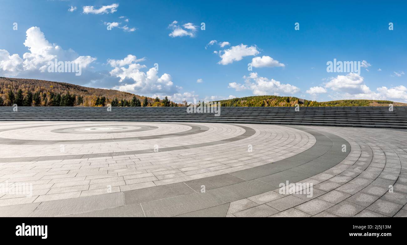 Empty square floor and mountains under blue sky Stock Photo