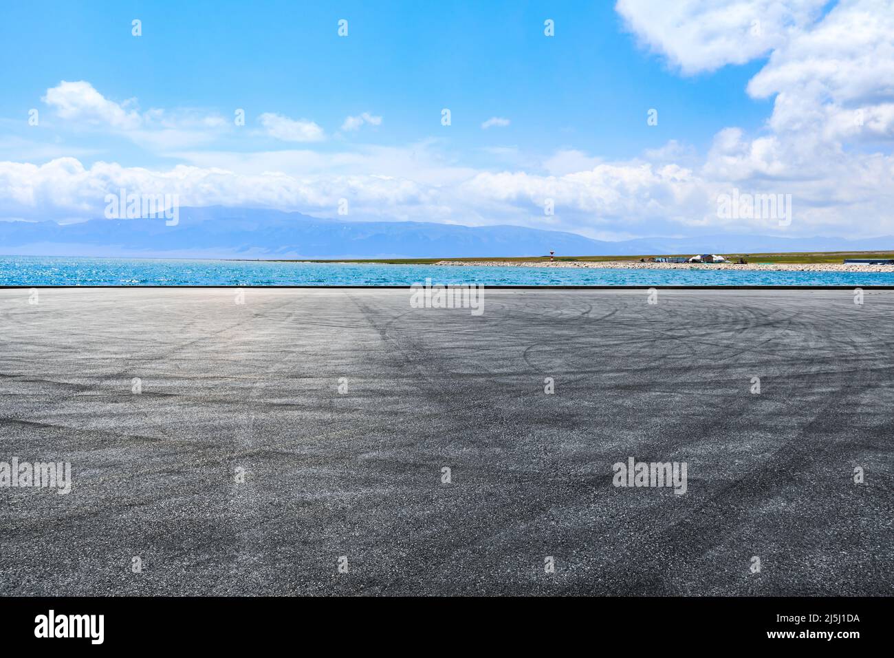 Asphalt road platforms and lake with mountain scenery Stock Photo