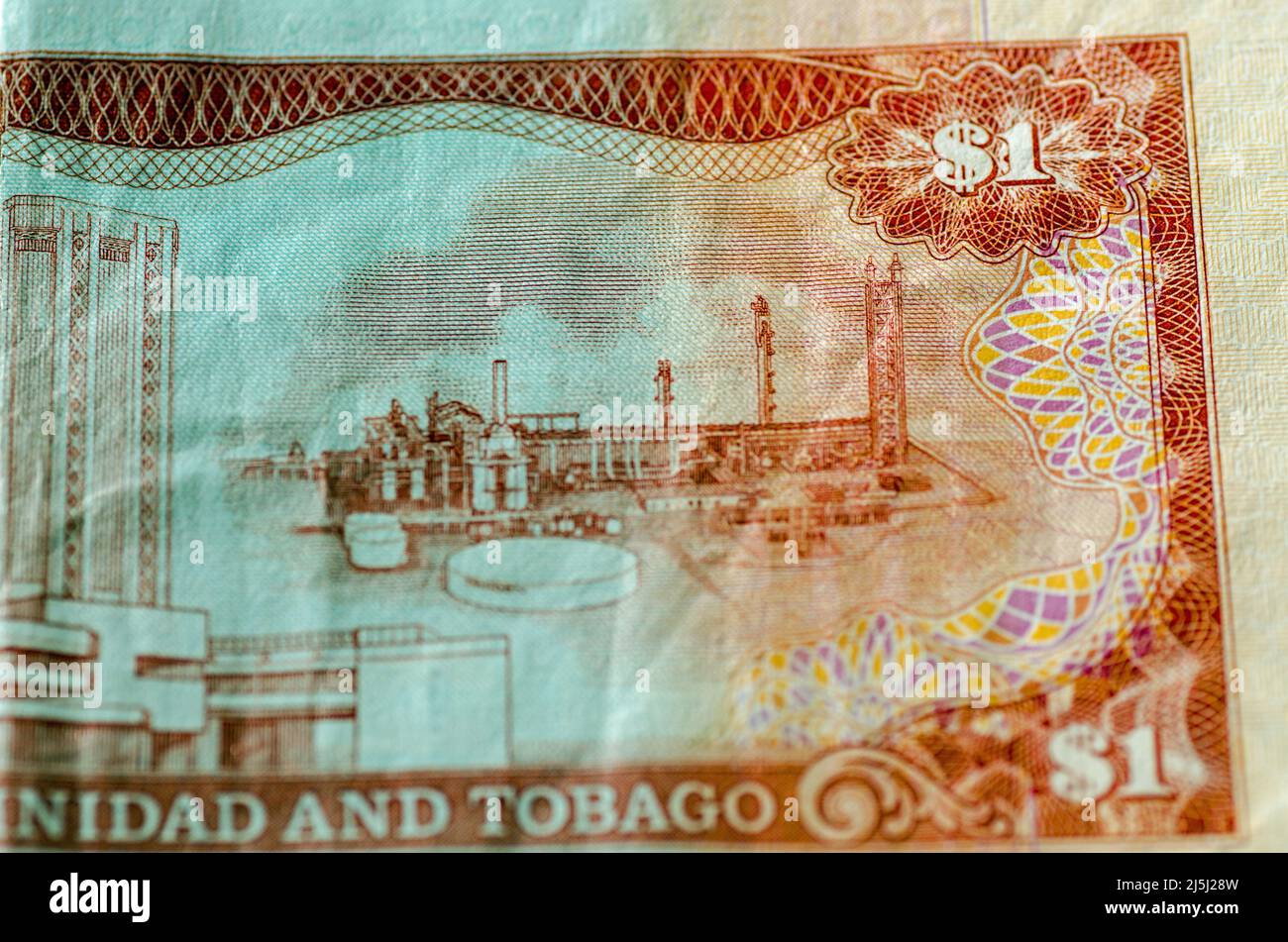 Detail of a used one dollar banknote from Trinidad and Tobago showing the anhydrous ammonia plant of the Trinidad Nitrogen Company at the Point Lisas Stock Photo
