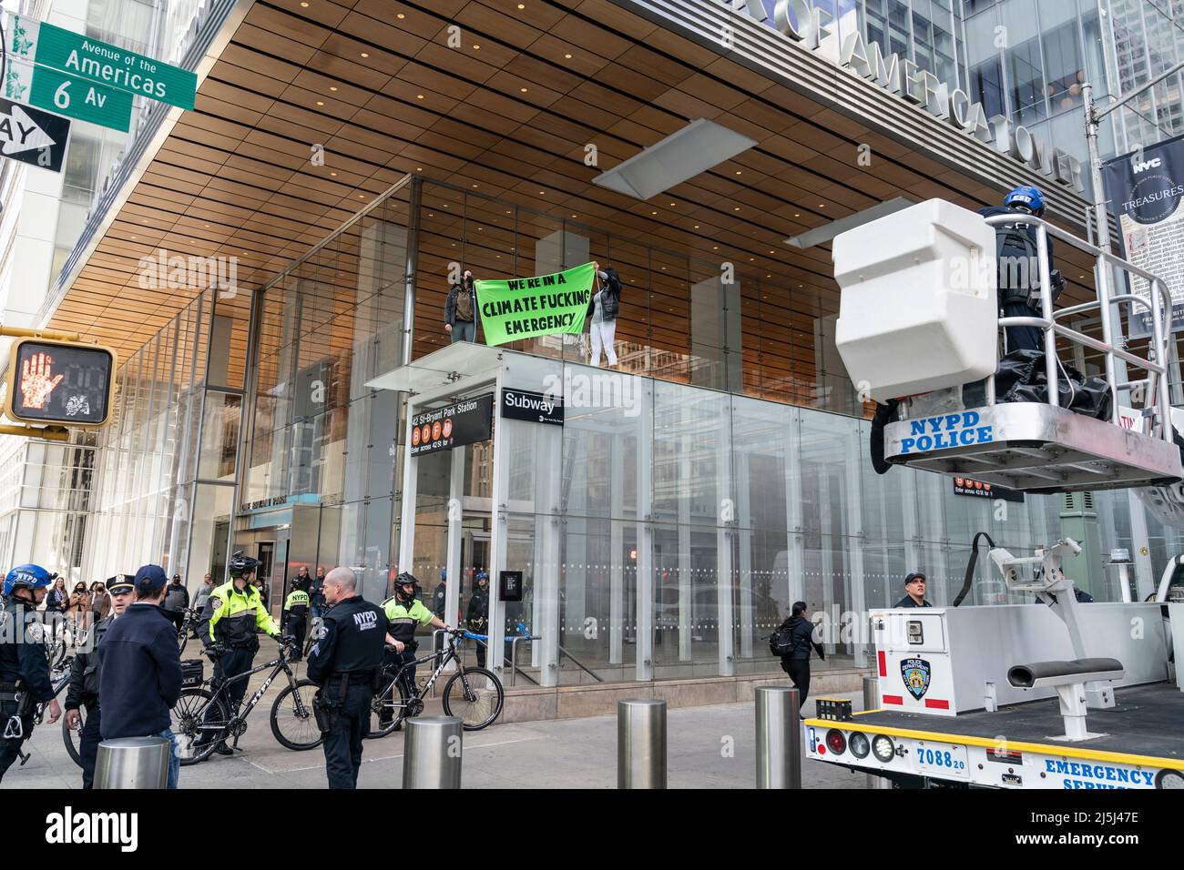 New York, NY - April 23, 2022: 2 activists from Extinction Rebellion climbed subway station, unveiled banner on 6th Avenue after conclusion of Annual March for Science and were arrested by police Stock Photo