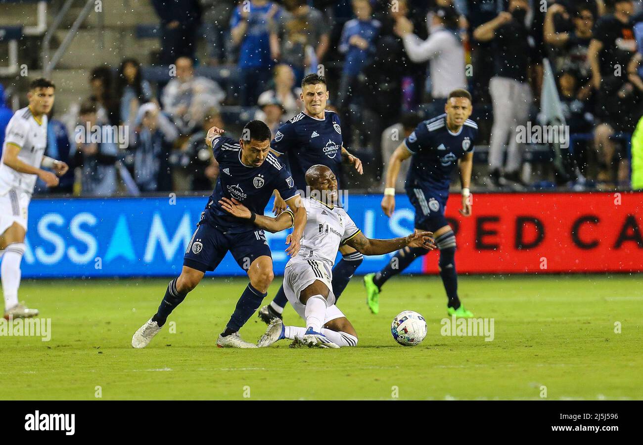 Columbus Crew midfielder Darlington Nagbe (6) gets taken down by Sporting KC midfielder Roger Espinoza (15) on April 23, 2022: MLS soccer game between Columbus Crew and the Sporting KC Children's Mercy Park in Kansas City, Kansas. Play during the second half of game. at David Beach/CSM Stock Photo