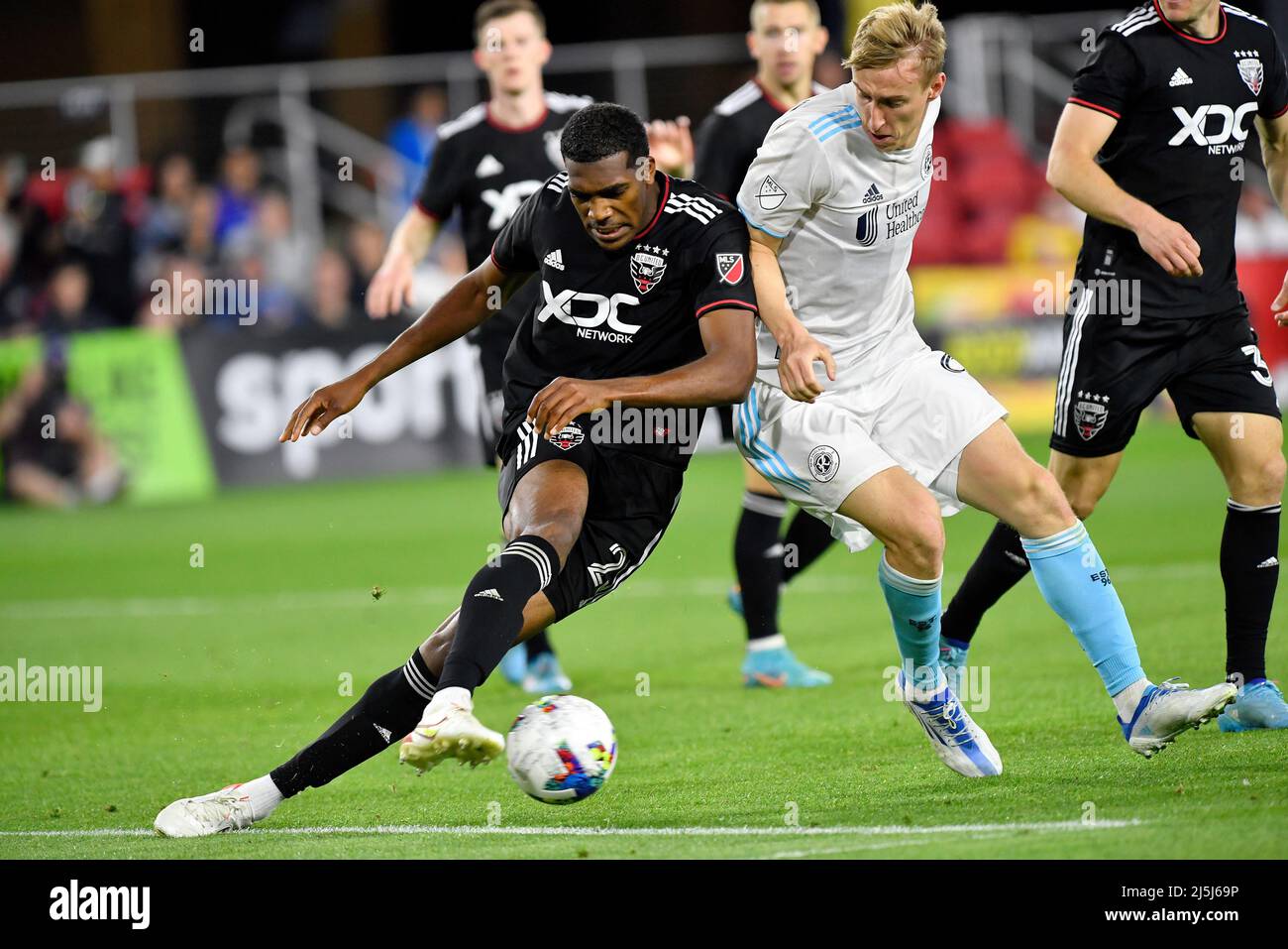 WASHINGTON, DC - APRIL 23: DC United defender Donovan Pines (23) clears a ball away from New England Revolution forward Adam Buksa (9) during the New England Revolution versus D.C. United Major League Soccer (MLS) game on April 23, 2022 at Audi Field in Washington, D.C. (Credit Image: © Randy Litzinger/Icon SMI via ZUMA Press) Stock Photo