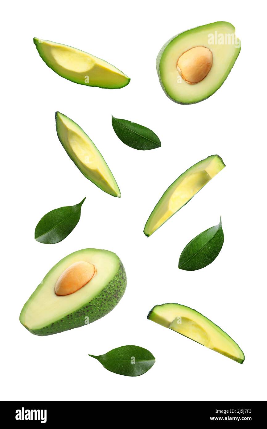 Fresh cut flying avocados isolated on white Stock Photo - Alamy
