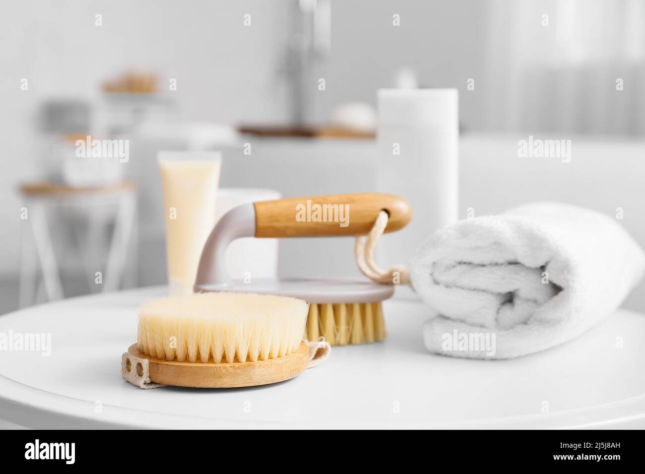 Body massage brushes and rolled towel on table Stock Photo Alamy