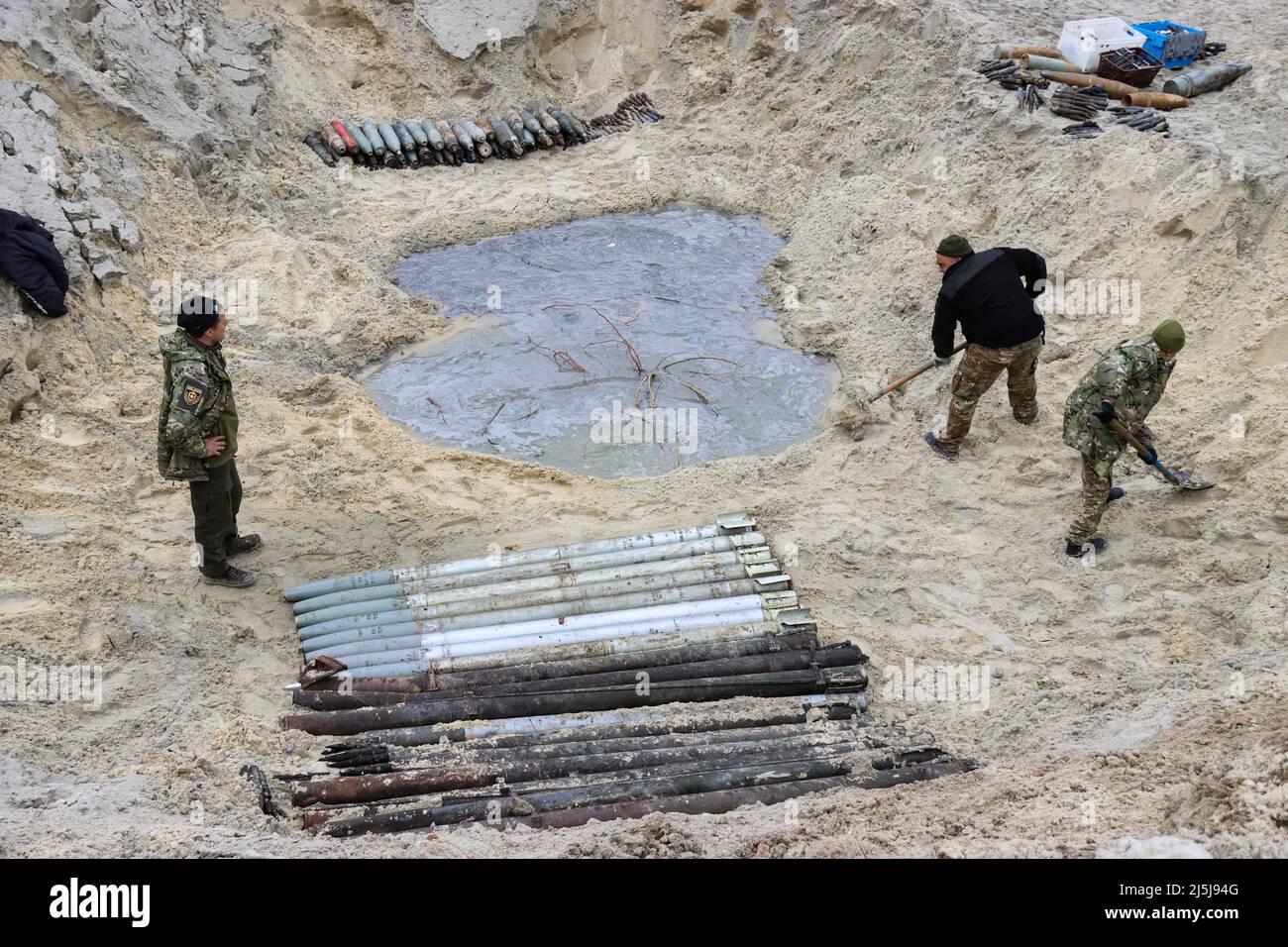 Soldiers work to dispose of ammunition collected in the territories