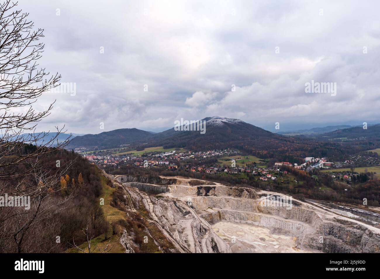 Limostone quarry on Kotouc hill, Koprivnice town and Cerveny kamena hill on the background in Czech republic during late autumn cloudy day Stock Photo