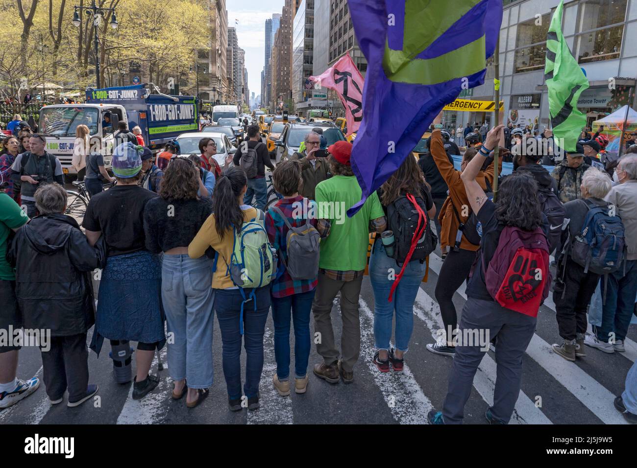 NEW YORK, NEW YORK - APRIL 23: Activists from Extinction Rebellion New York  City (XR-NYC) joined by marchers block traffic along 6th Avenue on April  23, 2022 in New York City. After
