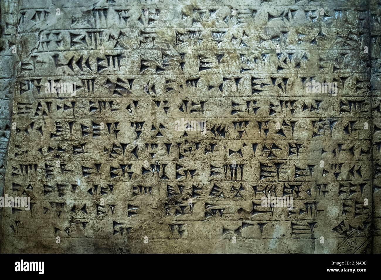 Ancient cuneiform writing script on the wall. High quality photo Stock Photo