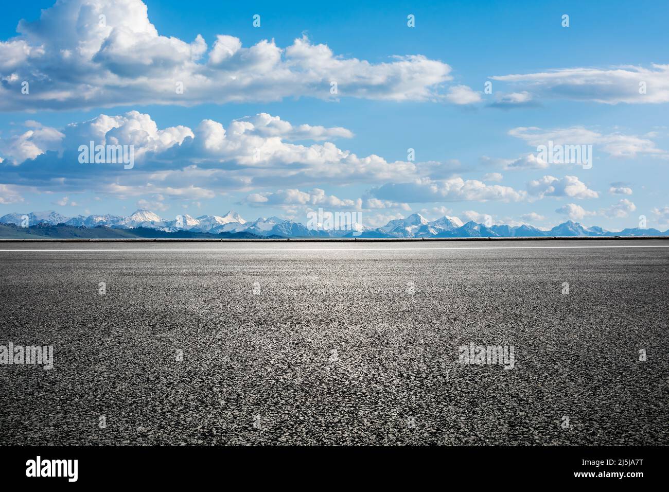 Asphalt road and snow mountain with sky cloud background Stock Photo