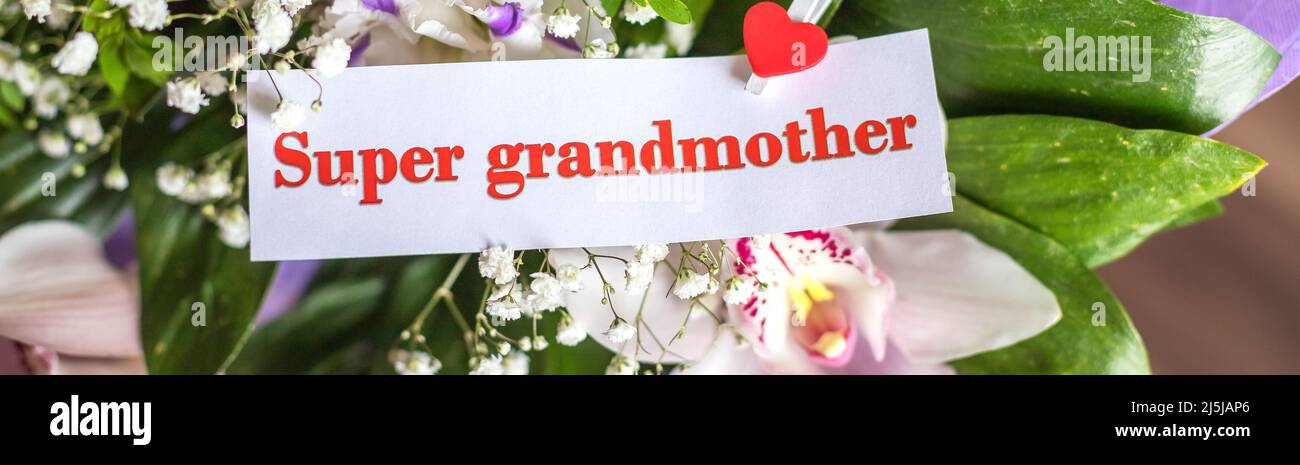 Beautiful greeting card and flowers for Mother's Day on white wooden ...