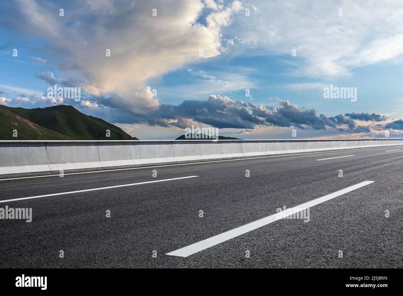 Asphalt road and mountain with sky clouds at sunset Stock Photo - Alamy