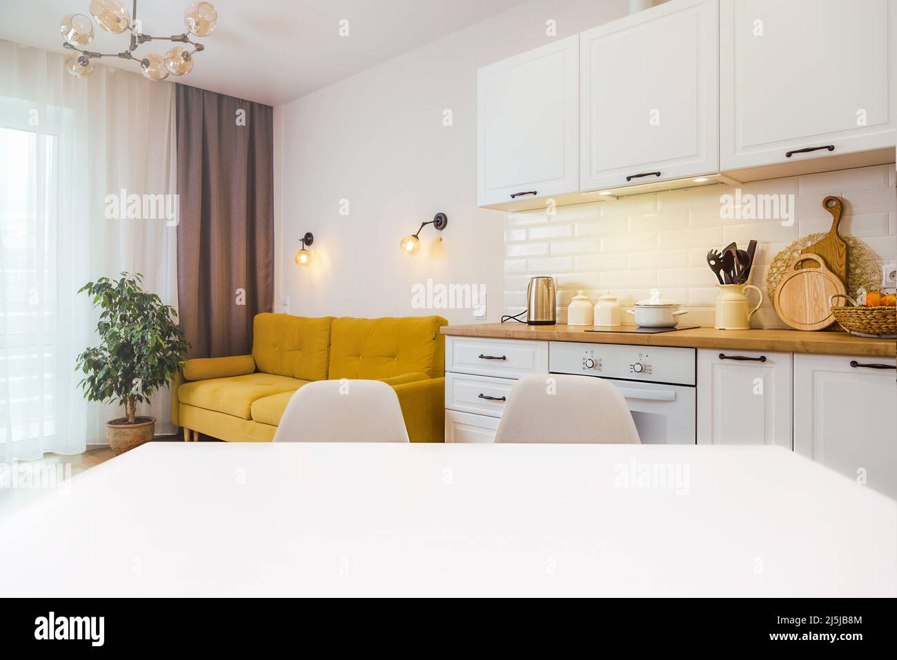 Mockup, empty table in bright kitchen interior. Copy paste for your design Stock Photo