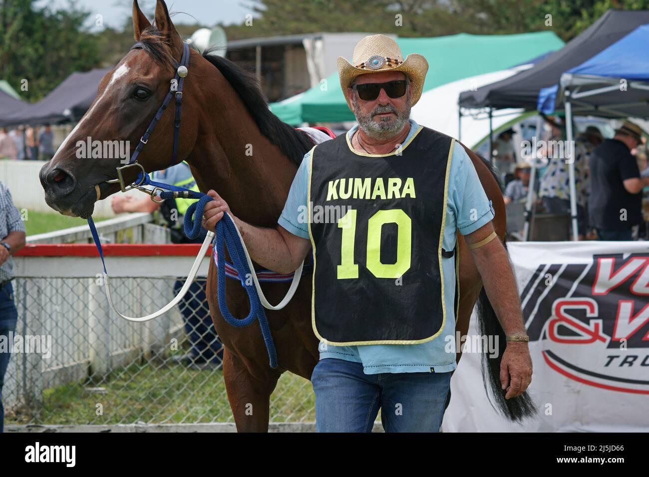 KUMARA, NEW ZEALAND, JANUARY 8, 2022; A trainer warms up his horse before a race at the Gold Nuggets competition at the Kumara Race Track, January 8, Stock Photo