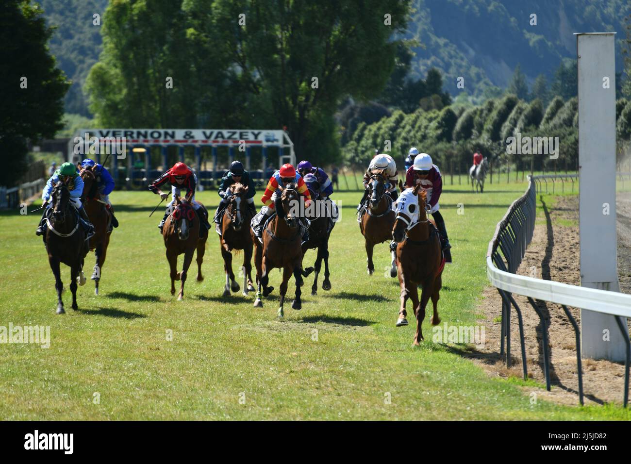 REEFTON, NEW ZEALAND, JANUARY 5 2022; jockeys ride their mounts hard to the finish line in a race at a country track meet, January 5, 2022 . Stock Photo