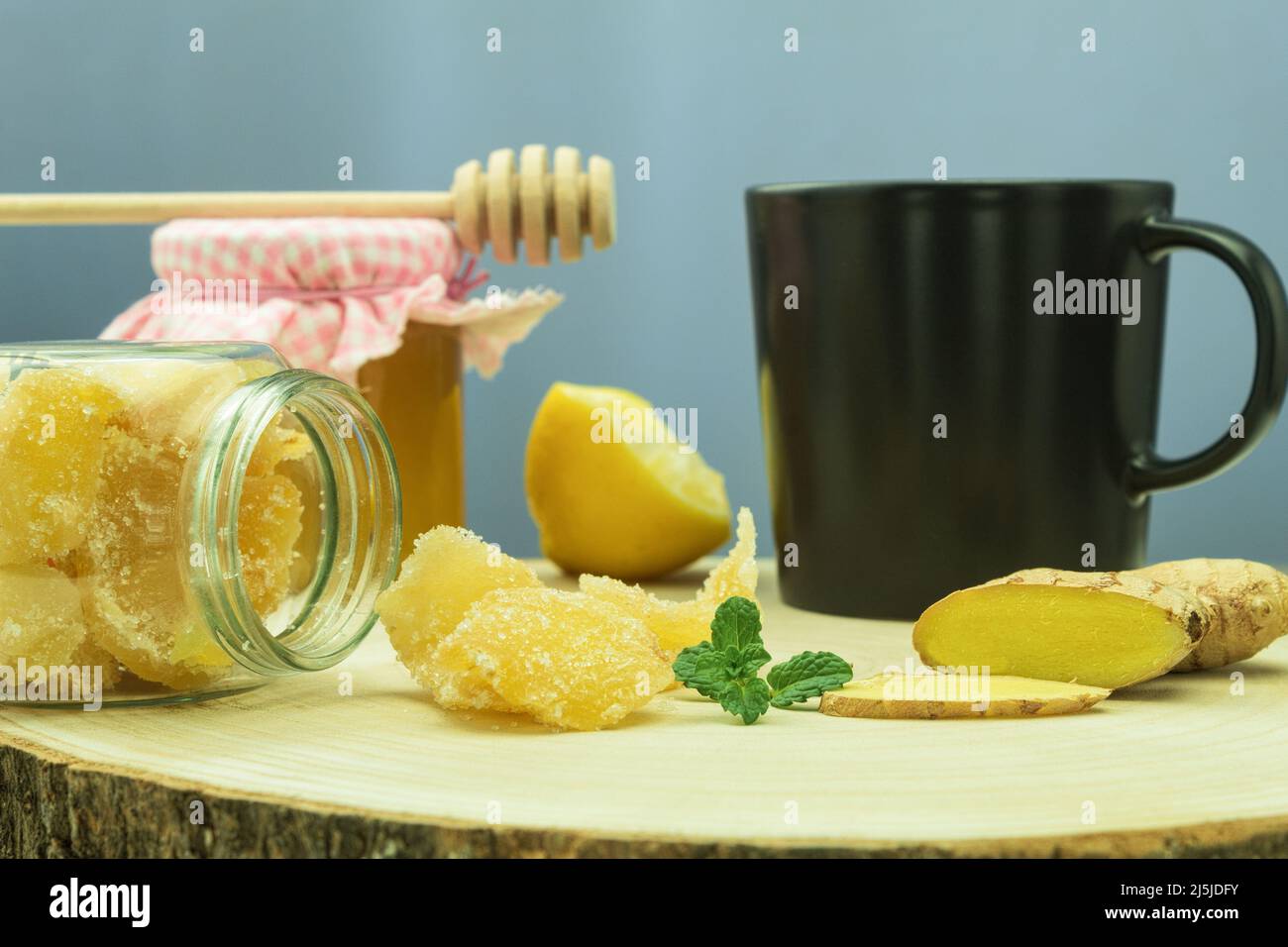 Three kinds of ginger ground spice fresh and candied on rustic table