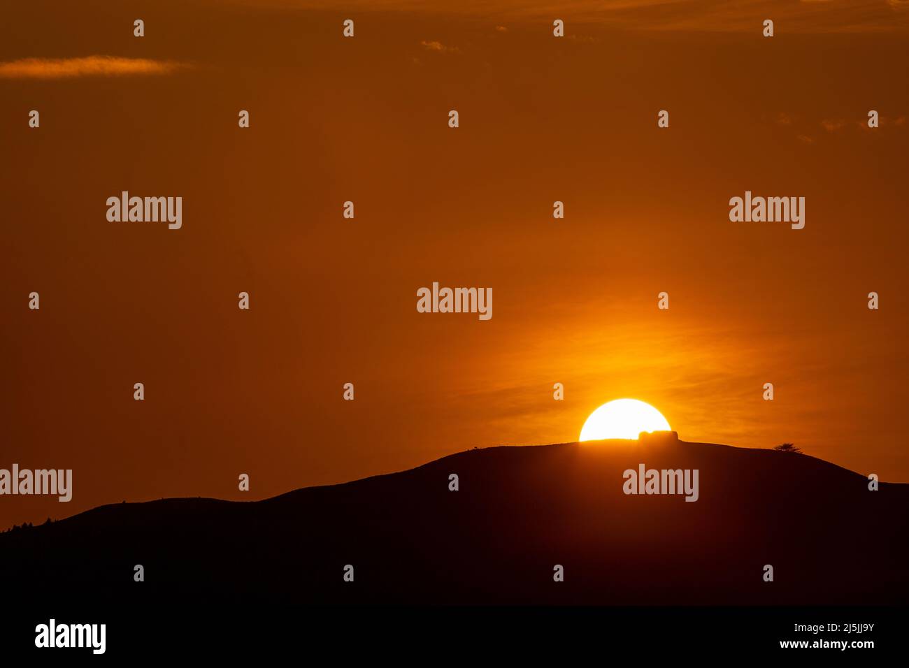Sunset over the Jubilee Tower on the summit of Moel Famau, North Wales Stock Photo