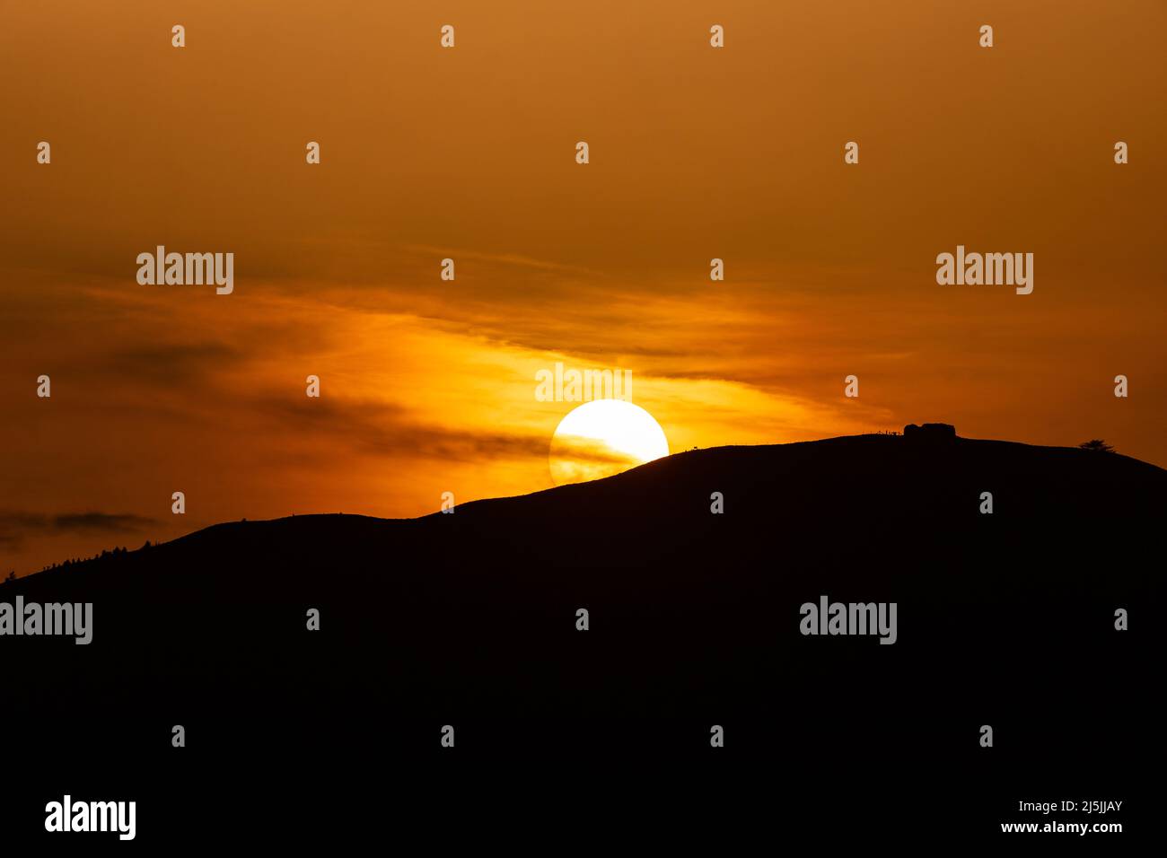 Sunset over the Jubilee Tower on the summit of Moel Famau, North Wales Stock Photo