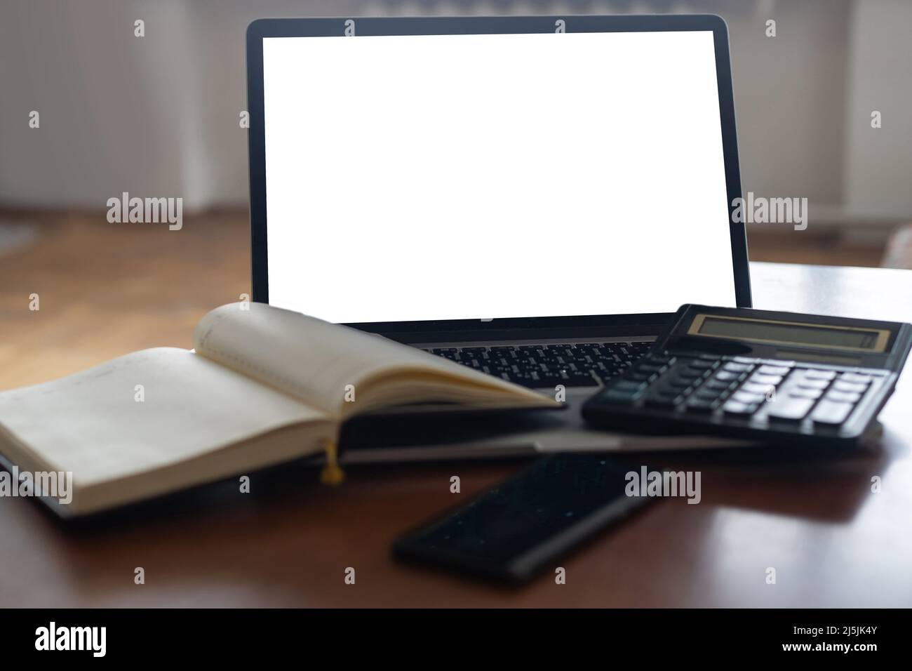 Workspace desk, calculator, Business image, Blank screen computer and supplies. laptop mock up screen view. work from home concept Stock Photo