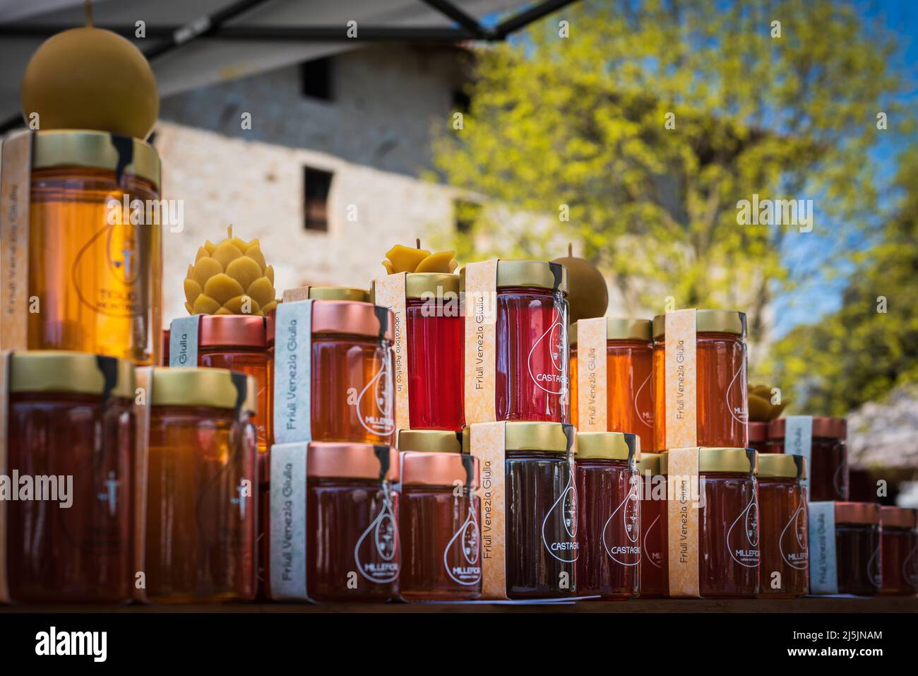 Honey in small jars for sale at an Italian open air market. Friuli Venezia Giulia artisanal food. Stock Photo