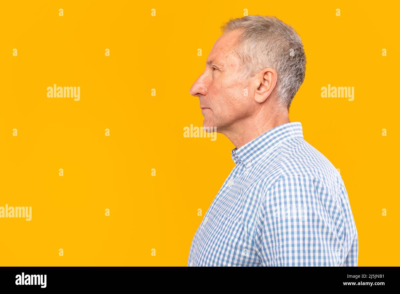 Serious mature man posing looking aside at studio Stock Photo