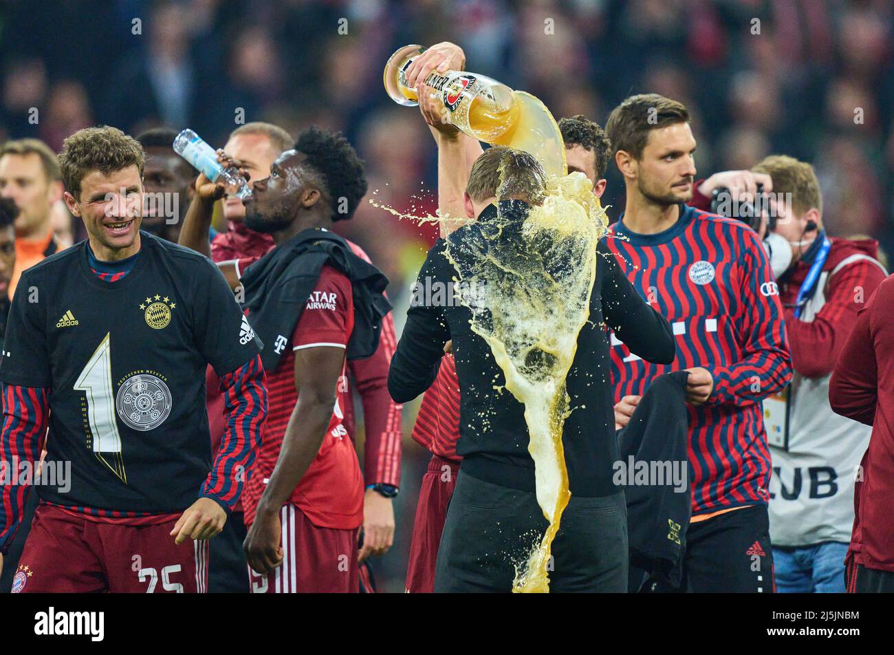 Benjamin PAVARD, FCB 5  beer shower for  Trainer Julian Nagelsmann (FCB), team manager, headcoach, coach,  Thomas MUELLER, MÜLLER, FCB 25  Alphonso DAVIES, FCB 19 Sven ULREICH, FCB 26 goalkeeper,   celebration after the match FC BAYERN MÜNCHEN - BORUSSIA DORTMUND 3-1 1.German Football League on April 23, 2022 in Munich, Germany. Season 2021/2022, match day 31, 1.Bundesliga, München, 31.Spieltag. FCB, BVB © Peter Schatz / Alamy Live News    - DFL REGULATIONS PROHIBIT ANY USE OF PHOTOGRAPHS as IMAGE SEQUENCES and/or QUASI-VIDEO - Stock Photo