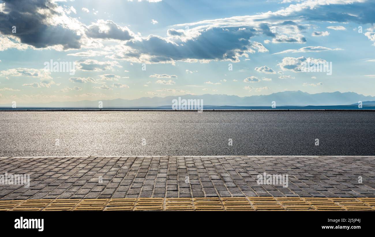 Asphalt road and mountain with sky cloud background Stock Photo - Alamy