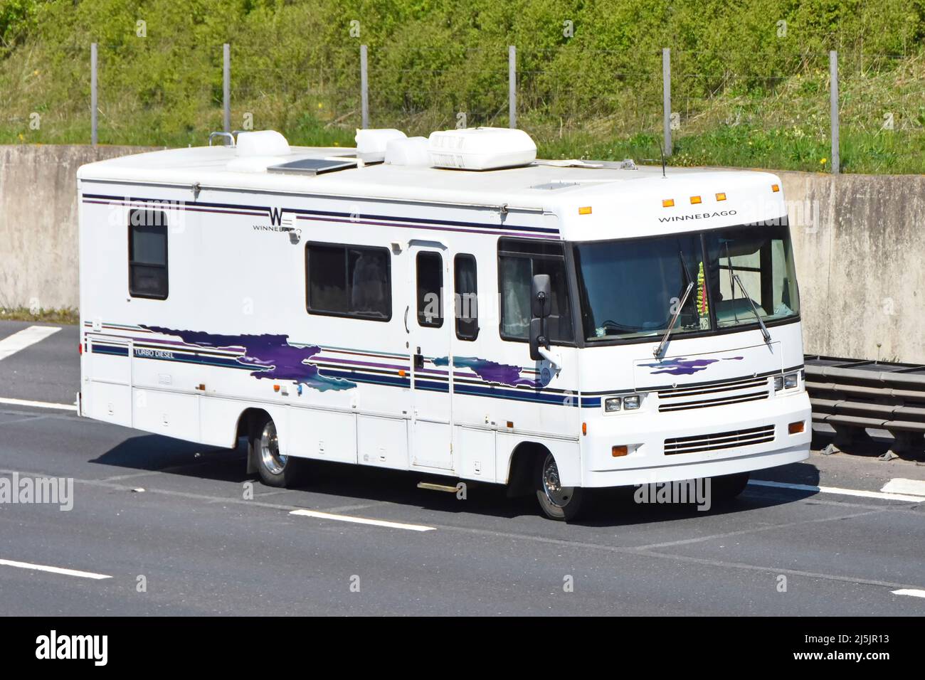 White American Winnebago Brave RV recreational vehicle motorhome camper van driving along