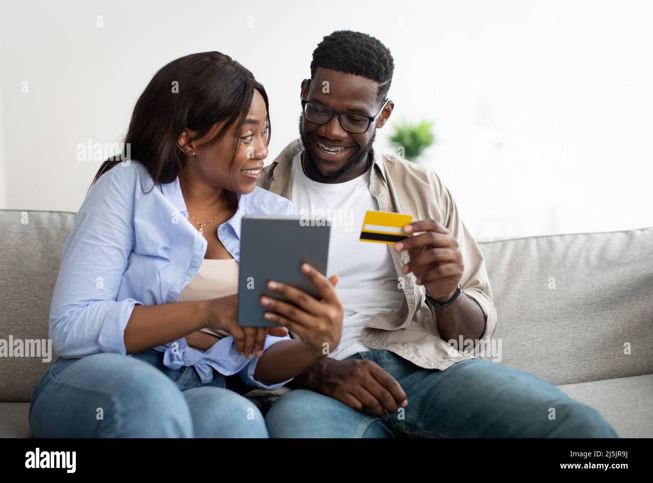 Excited couple using credit card hi-res stock photography and images ...