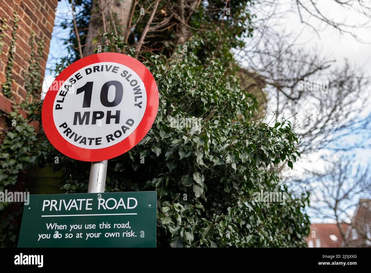 Speed limit sign on a private road asking users to please drive slowly. Pedestrian safety Stock