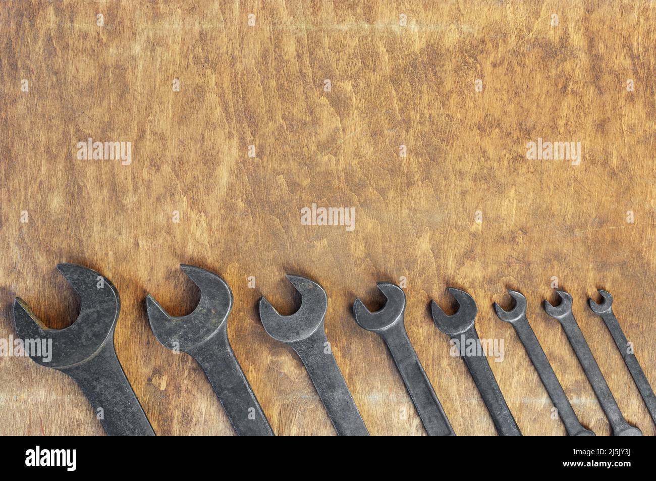 Set of old wrenches on wooden background Stock Photo