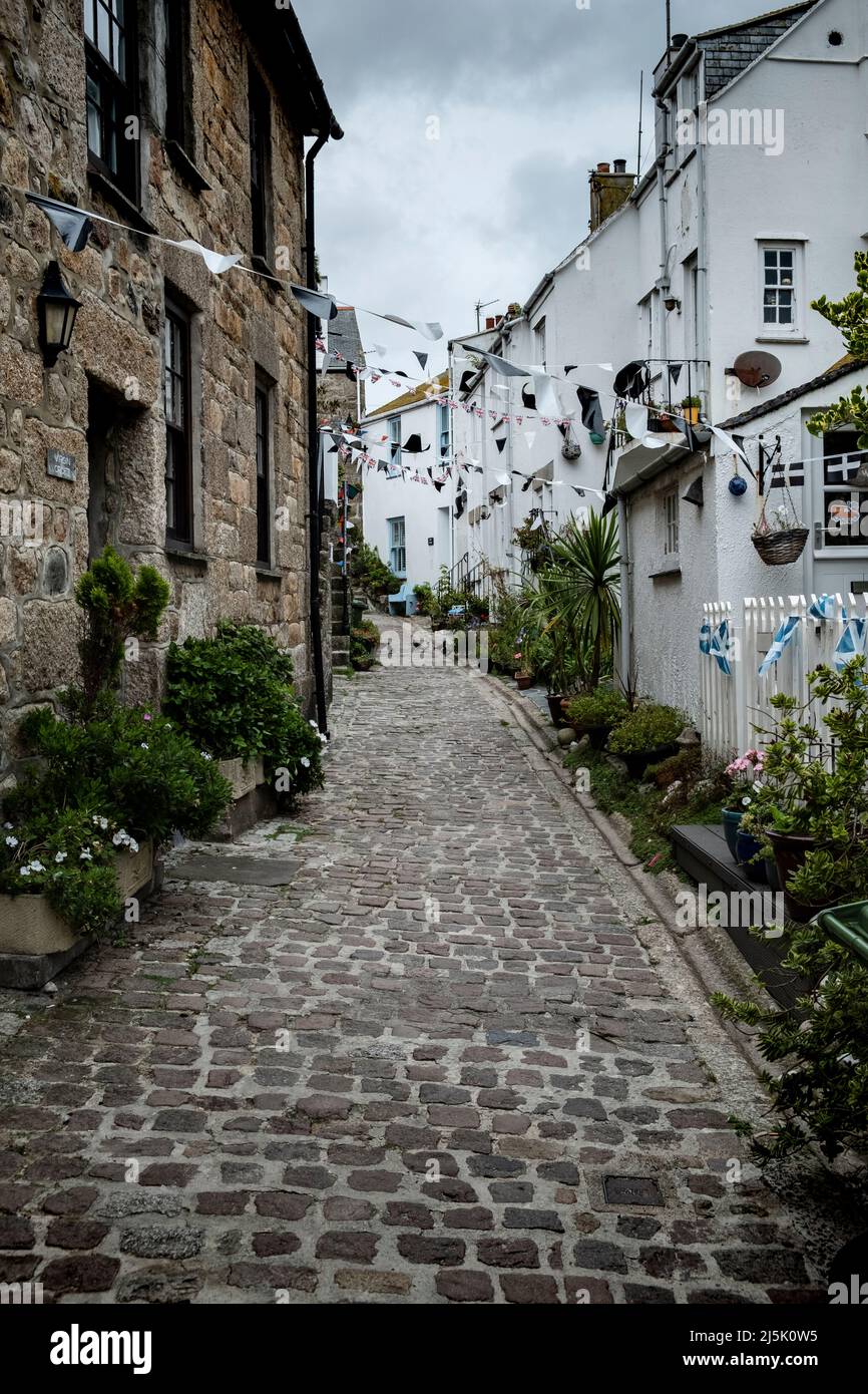 St Ives cobbled street with cornish Saint Piran's bunting Stock Photo