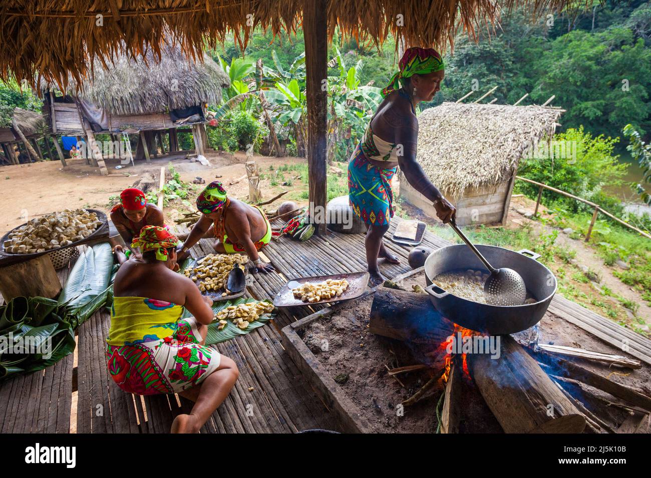 Embera puru indian woman are preparing and frying plantain in the Embera puru village, Republic of Panama, Central America. Stock Photo