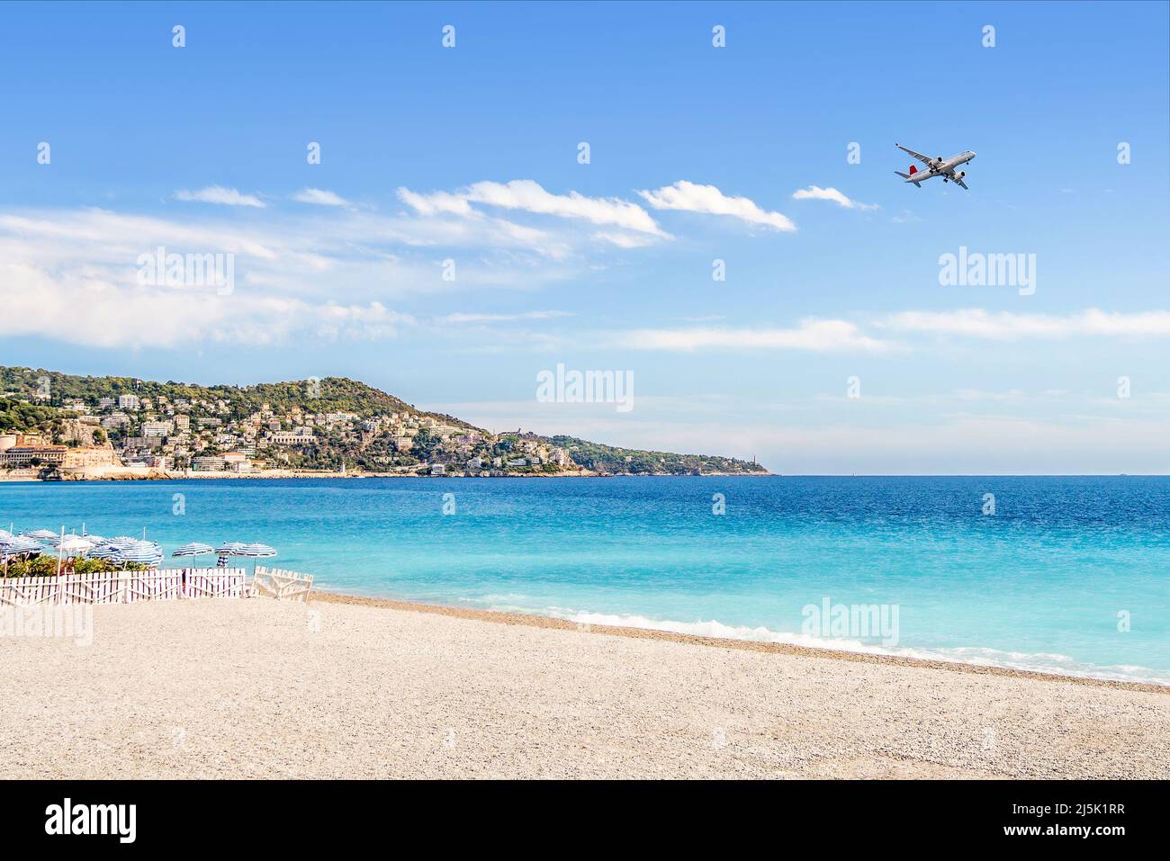 Beach and plane. Flight to vacation destination by the sea. Holiday landscape. Airline flying to summer paradise. Airplane on blue sky. Stock Photo
