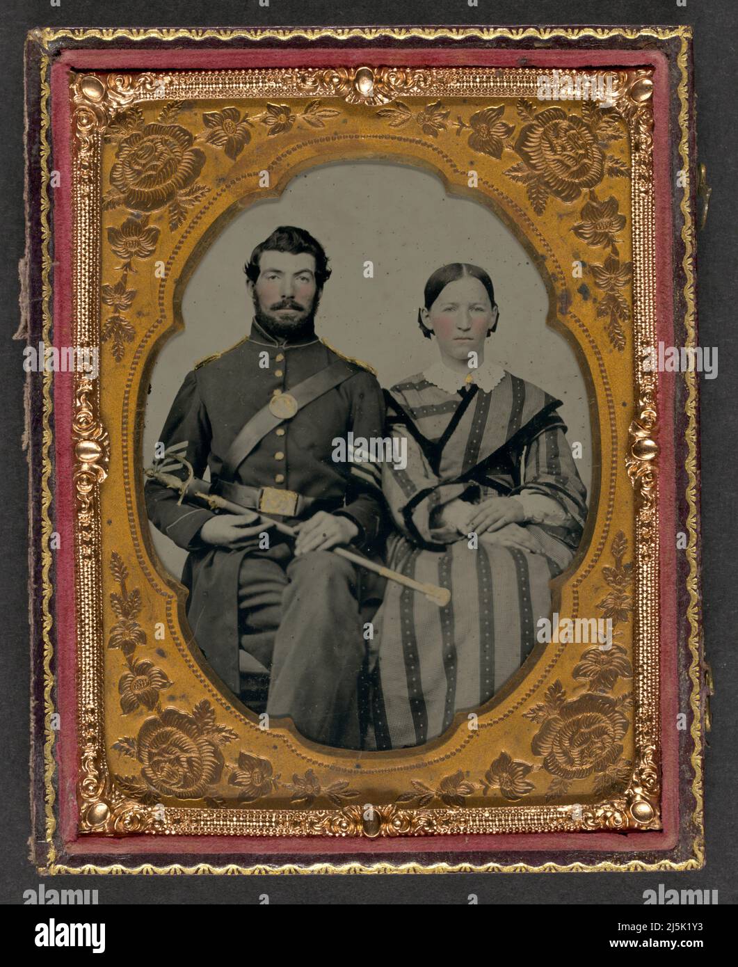 Unidentified soldier in Union sergeant's uniform with Model 1840 non-commissioned officer's sword next to unidentified woman Created / Published between 1861 and 1865  Subject Headings     -  United States.--Army--People--1860-1870      -  Soldiers--Union--1860-1870      -  Military uniforms--Union--1860-1870      -  Women--1860-1870      -  Couples--1860-1870      -  Daggers & swords--1860-1870      -  United States--History--Civil War, 1861-1865--Military personnel--Union  Headings     Ambrotypes--Hand-colored--1860-1870.      Group portraits--1860-1870.      Portrait photographs--1860-1870. Stock Photo
