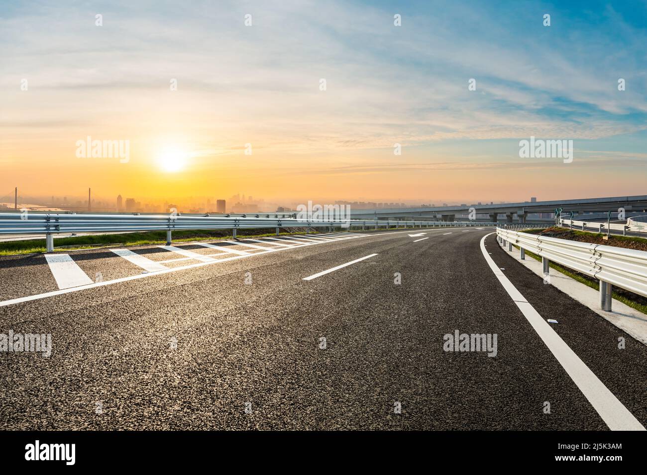 Empty asphalt road and beautiful sky clouds at sunrise Stock Photo