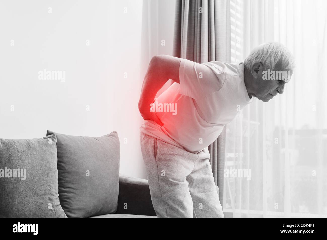Senior man is suffering from pain in lower back Stock Photo - Alamy