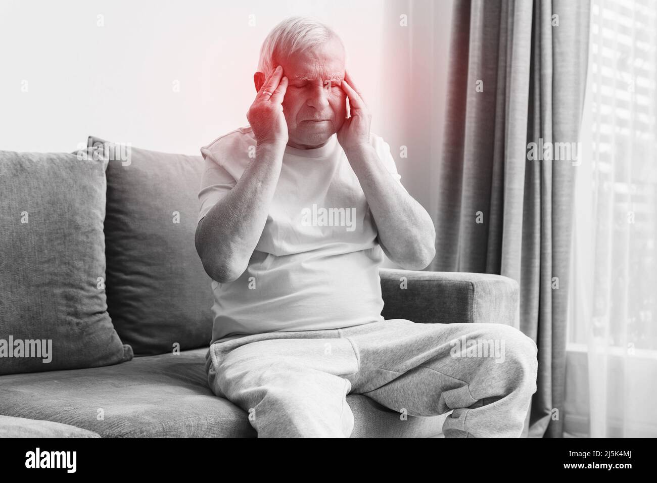Senior man suffering from headache at home Stock Photo - Alamy