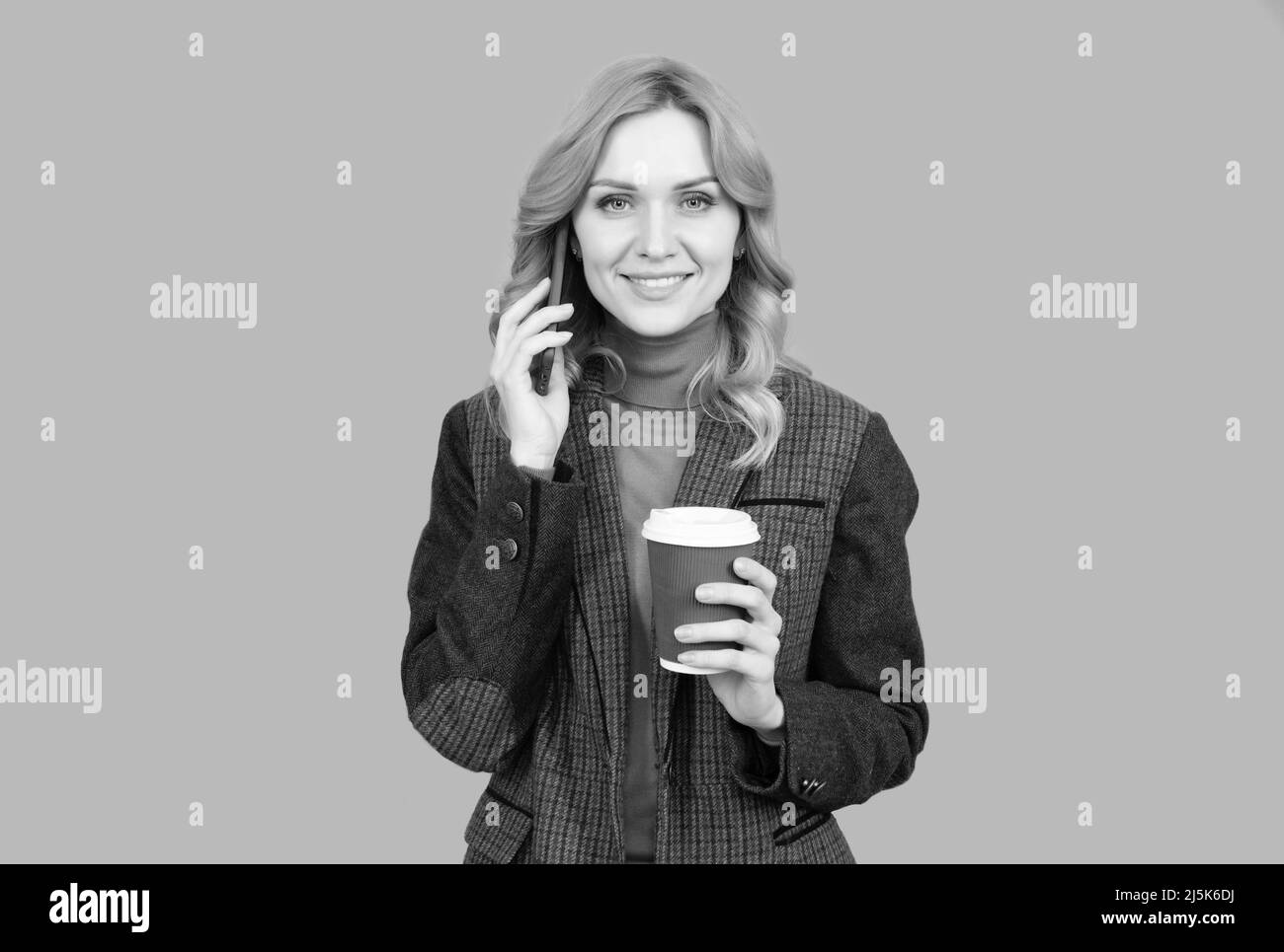 Woman talk on phone drinking coffee. Caffeine and smartphone addiction. Addiction to technology Stock Photo