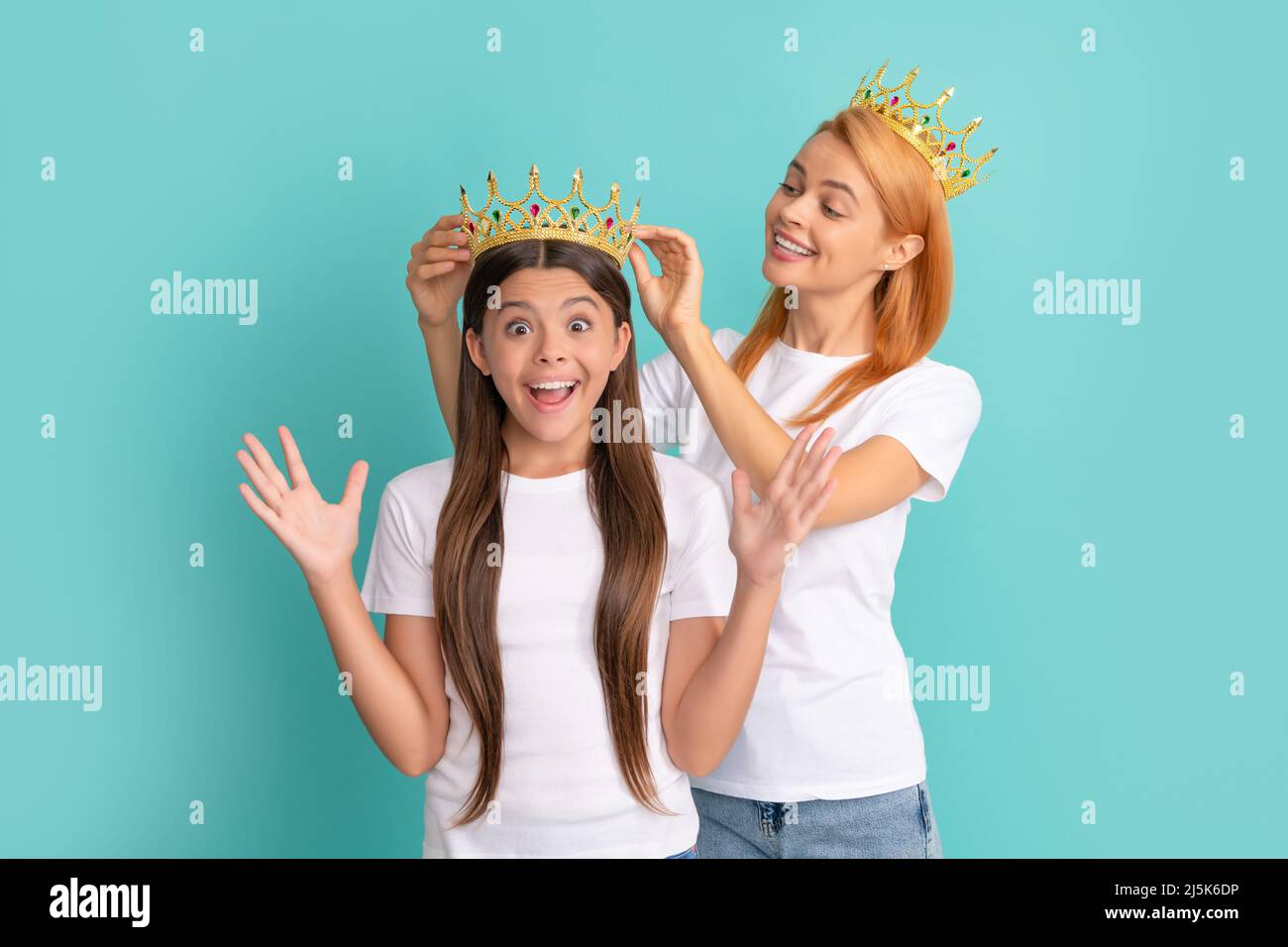 This is a happy surprise. Surprised child win crown. Happy mother crown daughter. Pageant girl Stock Photo